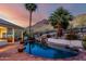 Inviting backyard pool featuring lush desert landscaping, waterfall feature, and tranquil mountain views at 2326 E Gardenia Dr, Phoenix, AZ 85020