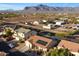 This aerial view shows the home with solar panels and desert surroundings at 2487 S Conestoga Rd, Apache Junction, AZ 85119