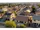 Expansive aerial view of a residential area featuring homes with tile roofs and well-maintained streets at 2487 S Conestoga Rd, Apache Junction, AZ 85119