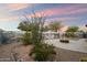 The backyard features a fire pit and unique desert landscaping at 2487 S Conestoga Rd, Apache Junction, AZ 85119