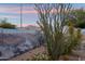 This backyard showcases its desert landscaping, a mural and beautiful mountain views at 2487 S Conestoga Rd, Apache Junction, AZ 85119