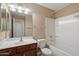 Bright bathroom featuring a single vanity, a large mirror, and a shower-tub combination at 2487 S Conestoga Rd, Apache Junction, AZ 85119