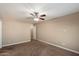 A bright and spacious bedroom featuring neutral paint, carpet flooring and a ceiling fan at 2487 S Conestoga Rd, Apache Junction, AZ 85119