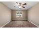 This bedroom features tan walls, carpeted floors and a ceiling fan with light at 2487 S Conestoga Rd, Apache Junction, AZ 85119