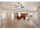 Open-concept living area with a kitchen, tile flooring, and access to the patio at 2487 S Conestoga Rd, Apache Junction, AZ 85119