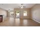 Spacious living area with neutral colors, tile floors, ceiling fans, and sliding glass doors to the backyard at 2487 S Conestoga Rd, Apache Junction, AZ 85119