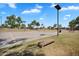 Community basketball court with lighting surrounded by landscaped green space at 24886 W Huntington Dr, Buckeye, AZ 85326