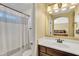 The bathroom features a vanity with a mirror and a combined bathtub and shower with curtain at 24886 W Huntington Dr, Buckeye, AZ 85326