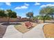 Inviting red bench along a scenic pathway, offering a relaxing spot in the community park at 24886 W Huntington Dr, Buckeye, AZ 85326