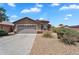 Single-Gathering home featuring a desert landscape, attached two-car garage, and neutral stucco exterior at 24886 W Huntington Dr, Buckeye, AZ 85326