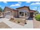 Charming single-Gathering home with a stucco exterior, tiled roof, and well-maintained desert landscaping at 24886 W Huntington Dr, Buckeye, AZ 85326