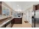 Well-lit kitchen features stainless steel appliances, ample countertop space, and an adjacent dining area at 24886 W Huntington Dr, Buckeye, AZ 85326