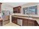Well-appointed kitchen with ample counter space, stainless steel appliances, and seamless flow to the living area at 24886 W Huntington Dr, Buckeye, AZ 85326