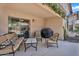 Covered patio with outdoor seating and grill, perfect for entertaining by the pool at 24886 W Huntington Dr, Buckeye, AZ 85326