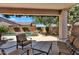 Covered patio featuring a comfortable seating area, overlooking a pool at 24886 W Huntington Dr, Buckeye, AZ 85326
