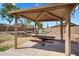 Covered picnic pavilion with metal picnic table near green space at 24886 W Huntington Dr, Buckeye, AZ 85326