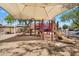 Covered playground with colorful equipment and soft surface, ideal for enjoyment at 24886 W Huntington Dr, Buckeye, AZ 85326