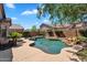 An inviting freeform pool is surrounded by a concrete patio and lush landscaping, perfect for enjoying sunny days at 24886 W Huntington Dr, Buckeye, AZ 85326