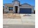 Charming single-story home with a blue garage door and a well-manicured lawn at 25466 W Graham Trl, Buckeye, AZ 85326