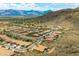 Aerial view of an established community with many homes, set against the mountain landscape at 2722 W Hiddenview Dr, Phoenix, AZ 85045