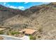 A high aerial view showcases the desert home surrounded by hills, offering stunning natural beauty and seclusion at 2722 W Hiddenview Dr, Phoenix, AZ 85045
