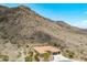 An aerial view capturing a custom home nestled in the desert landscape near the mountains at 2722 W Hiddenview Dr, Phoenix, AZ 85045