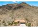 Expansive aerial view of a desert home, showcasing the tile roof and proximity to the mountain at 2722 W Hiddenview Dr, Phoenix, AZ 85045