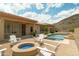 Relaxing backyard with pool, lounge area, and cozy fire pit at 2722 W Hiddenview Dr, Phoenix, AZ 85045