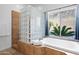 A soaking tub and glass block shower provide a luxurious bathing experience at 2722 W Hiddenview Dr, Phoenix, AZ 85045