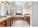 Bathroom boasts double vanities, a large window, and a separate tub for relaxation and pampering at 2722 W Hiddenview Dr, Phoenix, AZ 85045