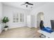 Neutral bedroom features wood-look floors, bright windows, and white trim at 2722 W Hiddenview Dr, Phoenix, AZ 85045
