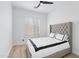 Comfortable bedroom with wood floor, ceiling fan, and bright window at 2722 W Hiddenview Dr, Phoenix, AZ 85045