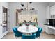 Charming breakfast nook with pool views, designer lighting, and stylish blue chairs at 2722 W Hiddenview Dr, Phoenix, AZ 85045