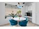 Bright breakfast nook with marble table, stylish blue chairs, and a large window view of the pool at 2722 W Hiddenview Dr, Phoenix, AZ 85045