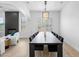 Spacious dining room with modern chandelier and long table, seamlessly connected to the living area at 2722 W Hiddenview Dr, Phoenix, AZ 85045