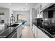 Stunning kitchen with white cabinets, black countertops, a breakfast nook, and modern appliances at 2722 W Hiddenview Dr, Phoenix, AZ 85045