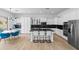 Bright, modern kitchen featuring white cabinets, a black marble backsplash, and stainless steel appliances at 2722 W Hiddenview Dr, Phoenix, AZ 85045