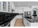 Modern kitchen with white cabinetry, black marble countertops, and stainless steel appliances at 2722 W Hiddenview Dr, Phoenix, AZ 85045