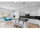 Spacious kitchen with modern design, featuring white cabinetry, black countertops, and island seating at 2722 W Hiddenview Dr, Phoenix, AZ 85045