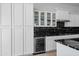 Modern kitchen featuring black marble counters, white cabinetry and a built-in wine fridge at 2722 W Hiddenview Dr, Phoenix, AZ 85045