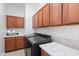 Convenient laundry room features modern appliances and ample cabinet storage at 2722 W Hiddenview Dr, Phoenix, AZ 85045