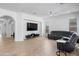 Bright living room with modern decor, open layout, and a large screen TV for entertainment at 2722 W Hiddenview Dr, Phoenix, AZ 85045