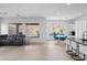 Open-concept living room featuring modern furnishings, a breakfast nook, and seamless indoor-outdoor living at 2722 W Hiddenview Dr, Phoenix, AZ 85045