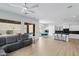 Bright open-concept living area with modern light fixtures and seamless flow to the kitchen and outdoor pool at 2722 W Hiddenview Dr, Phoenix, AZ 85045