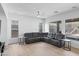 Open living space showcases a gray sectional sofa, modern fixtures, and natural light from multiple windows at 2722 W Hiddenview Dr, Phoenix, AZ 85045