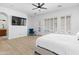 Sunlit bedroom featuring a comfortable king bed, neutral colors, and a modern ceiling fan at 2722 W Hiddenview Dr, Phoenix, AZ 85045