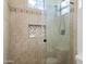 Close-up of shower with tiled walls, glass door, and recessed niche at 2722 W Hiddenview Dr, Phoenix, AZ 85045