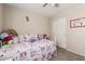 Bedroom with a ceiling fan, plush pillows, a bed with a unique design, and a closet for storage at 2813 N 107Th Dr, Avondale, AZ 85392
