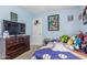 Bedroom with wall decor, a TV on a dresser, and a closet for organized storage at 2813 N 107Th Dr, Avondale, AZ 85392