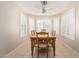 Bright dining room with wooden table and chairs, tile floor and large window with shutters at 2813 N 107Th Dr, Avondale, AZ 85392